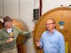 two men discuss the merits of a glass of wine