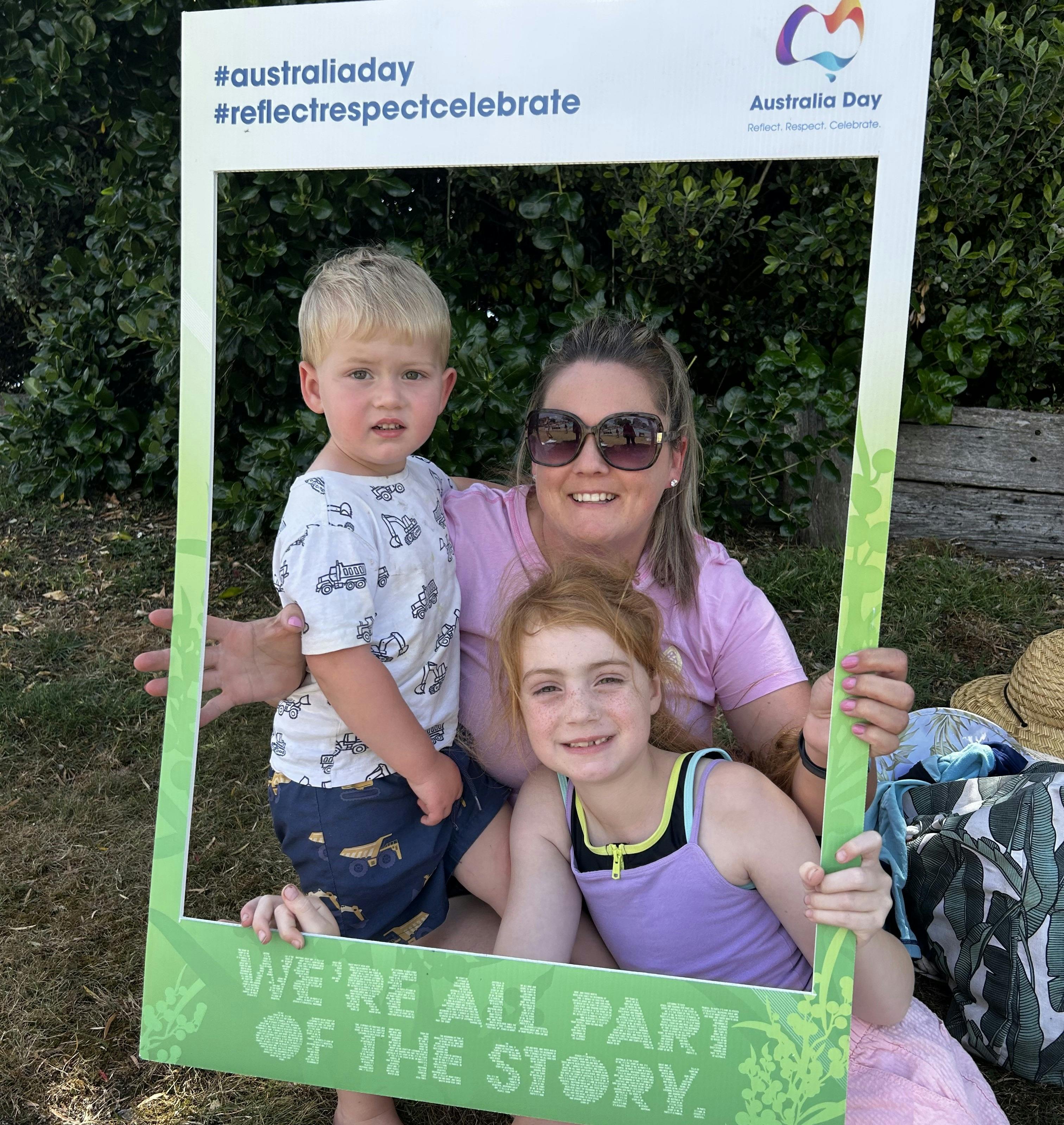 Family holding up "Aus Day' selfie board