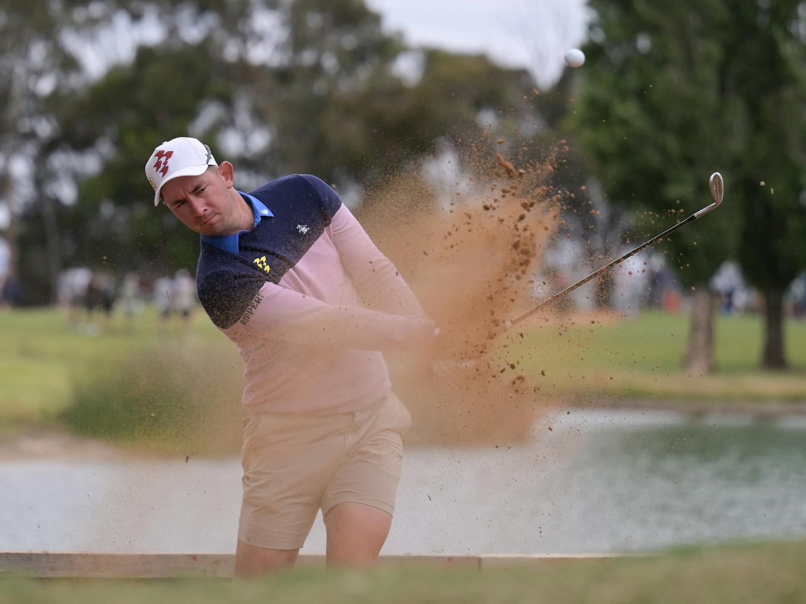 Golfer Hitting out of Bunker
