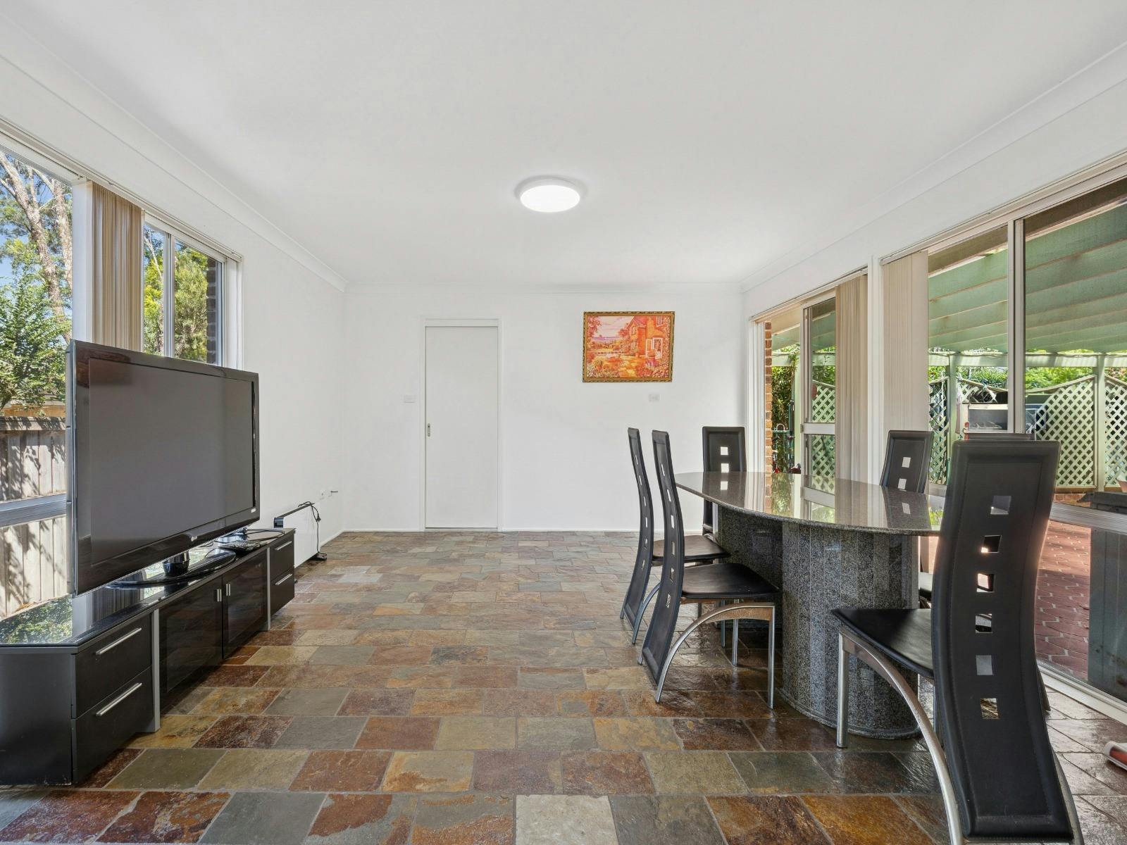 Common living and dining area with TV, dining table, and open-plan layout.