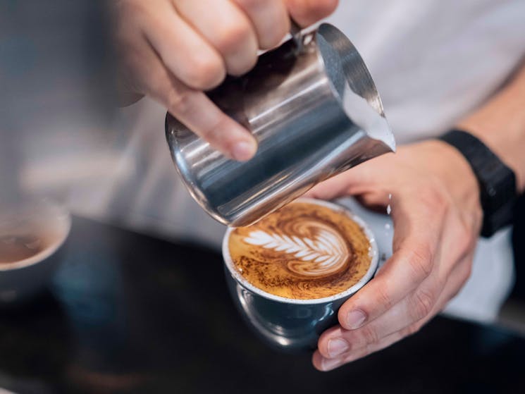 Barista making a cup of coffee at the Rising Sun Workshop cafe