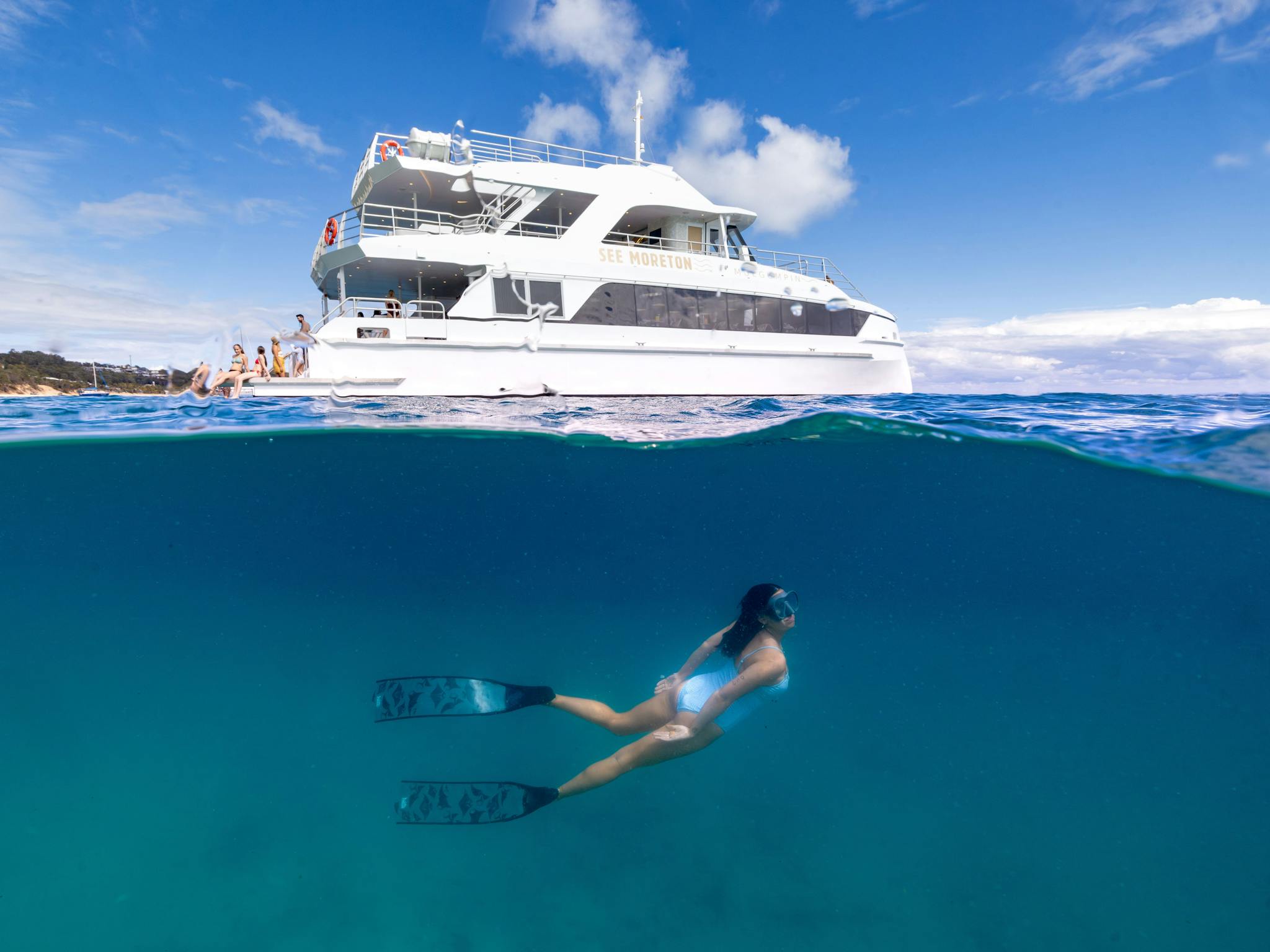 Girl snorkelling with See Moreton in the background Girl snorkelling with See Moreton in the background