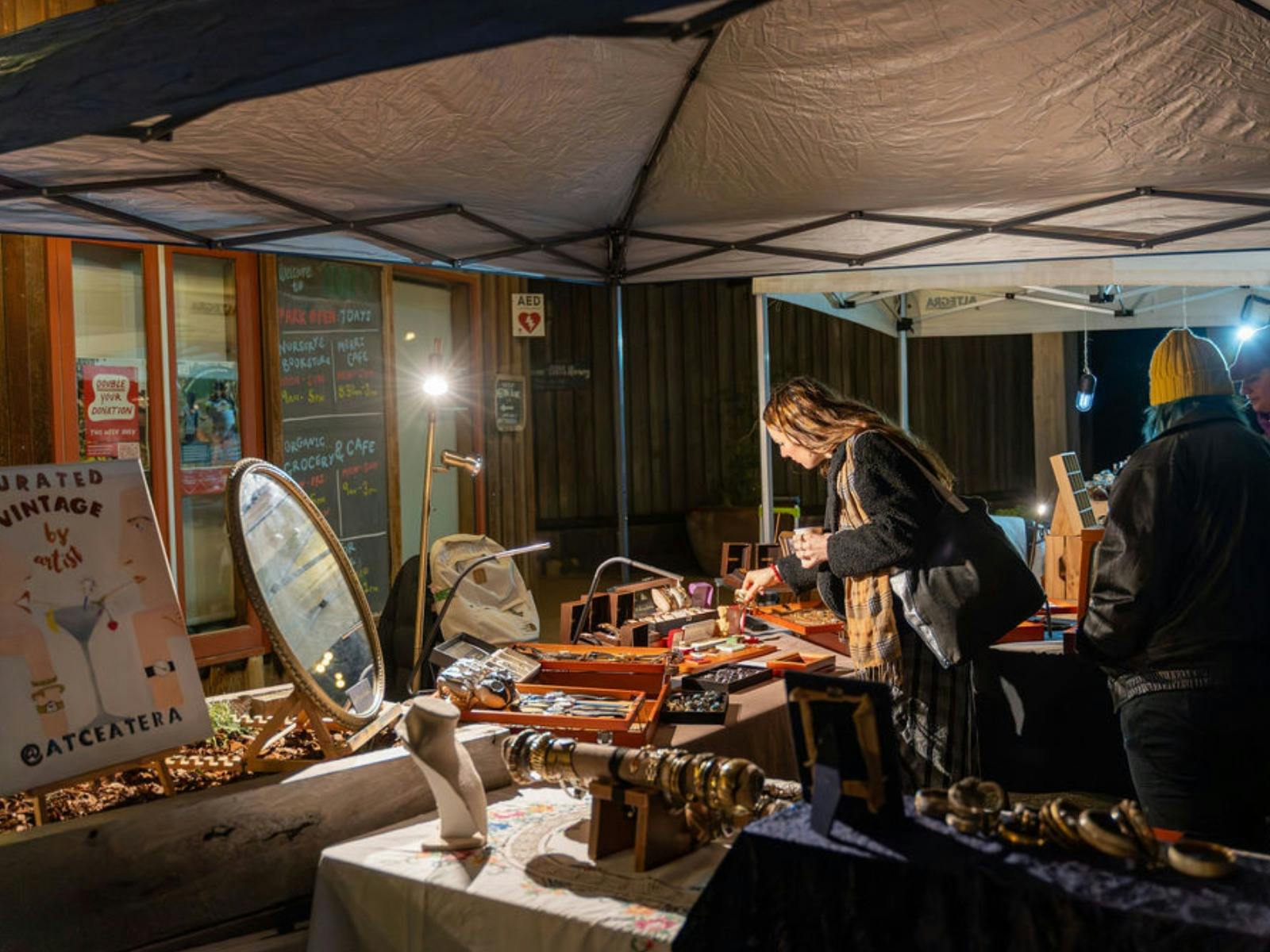 People peruse a market stall