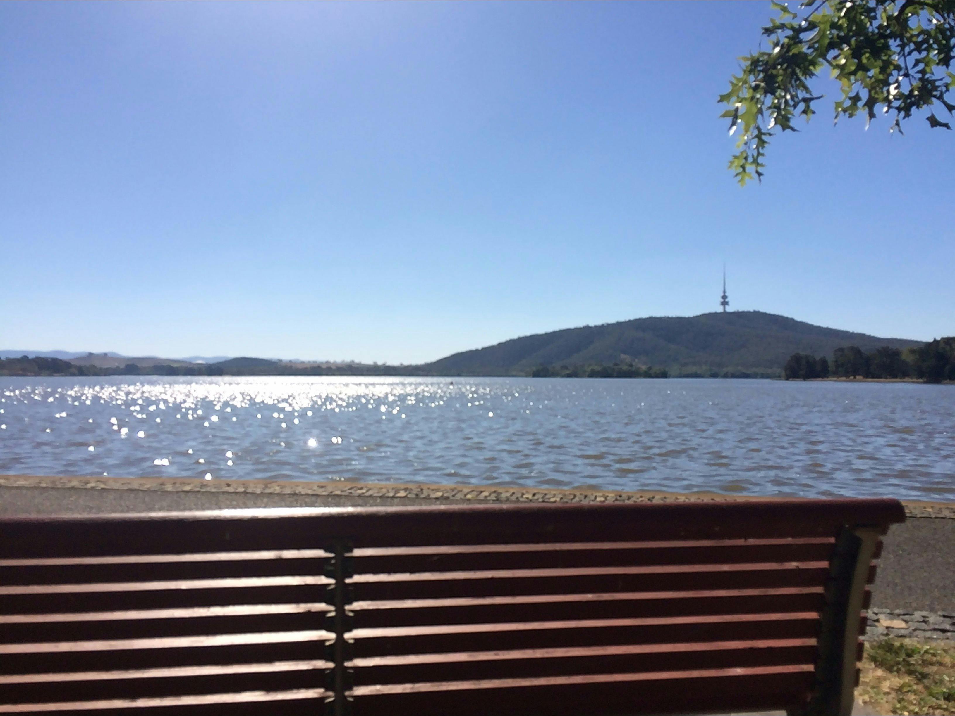Park bench facing the lake with views of Black Mountain and Telstra Tower