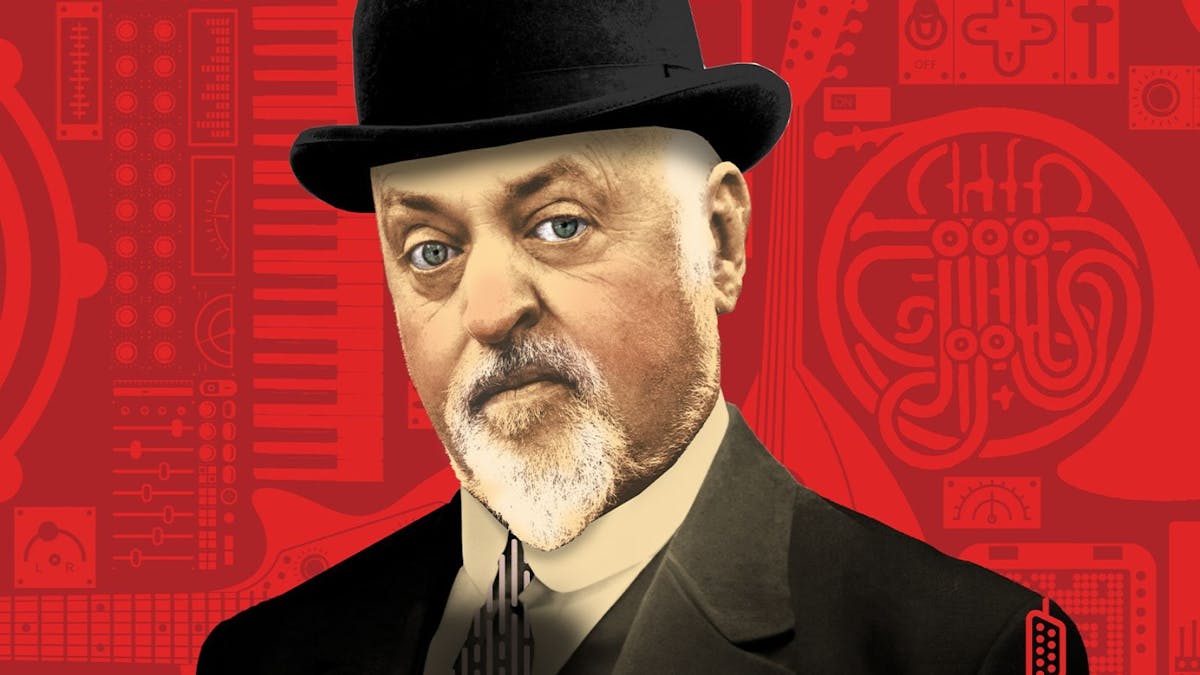 Bill Bailey with red background and wearing a tophat
