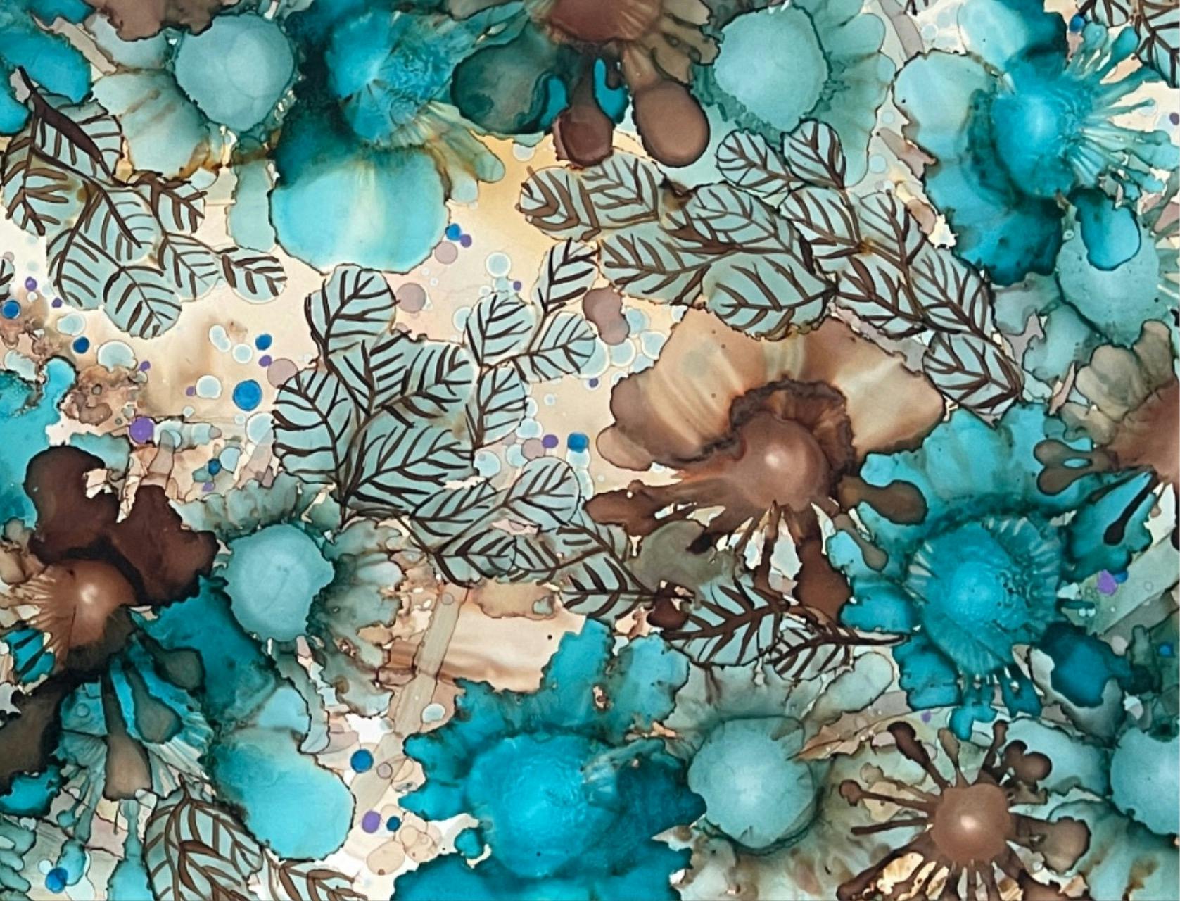 Blue a brown flowers flow across the paper from alcohol ink artwork