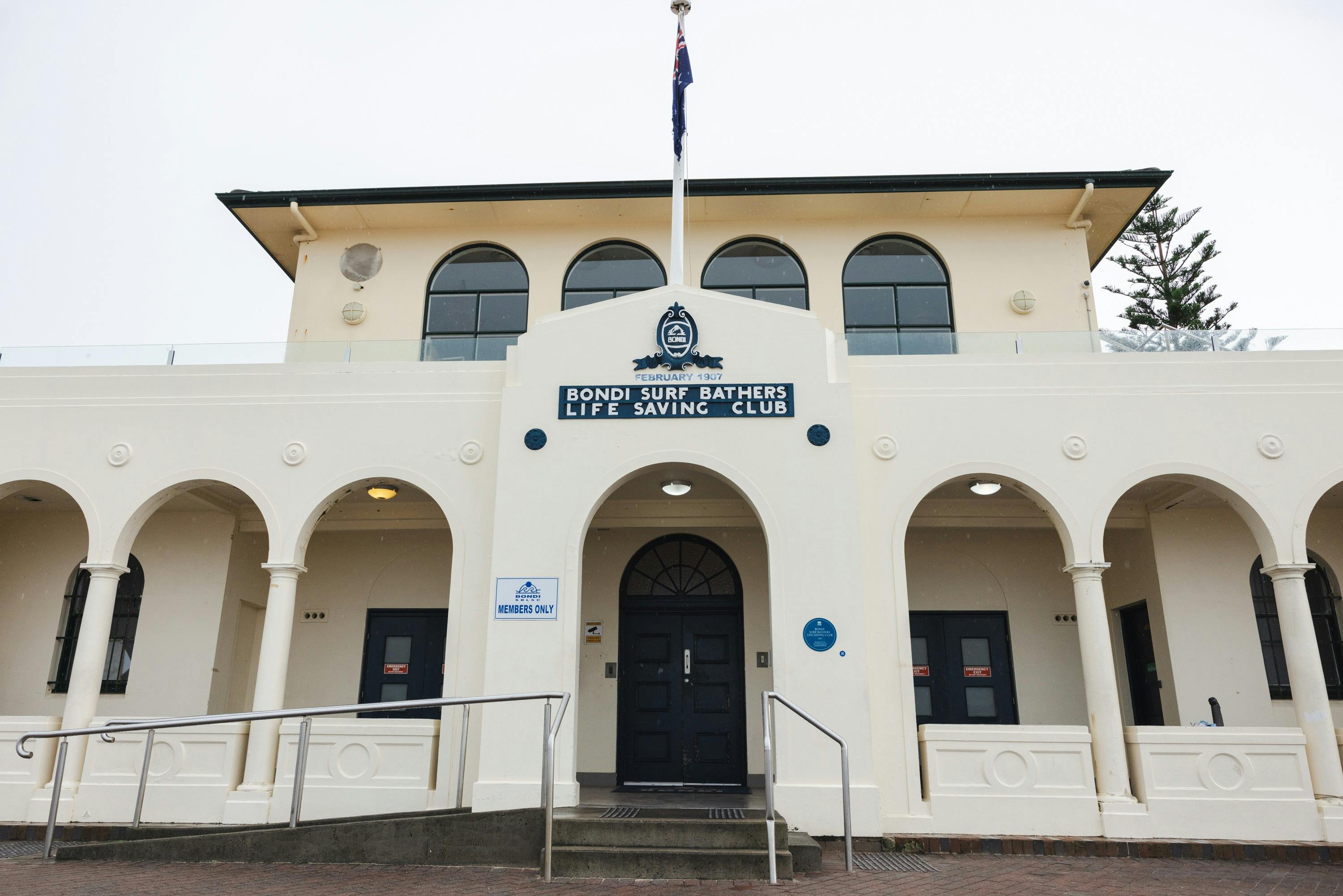 Blue plaque on front of building with sign Bondi Surf Bathers Life Saving Club
