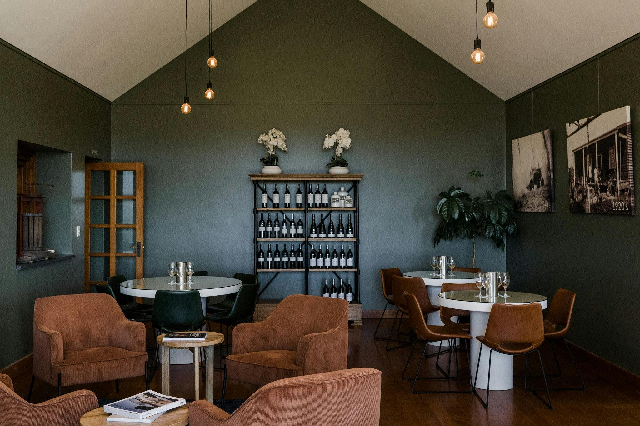 Interior of Credaro Cellar Door with lounge chairs, dining chairs & white tables