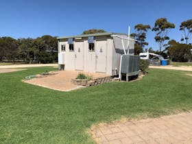 A clean, standalone toilet facility at Cummins Park and Cabin Park, set within the park’s open groun