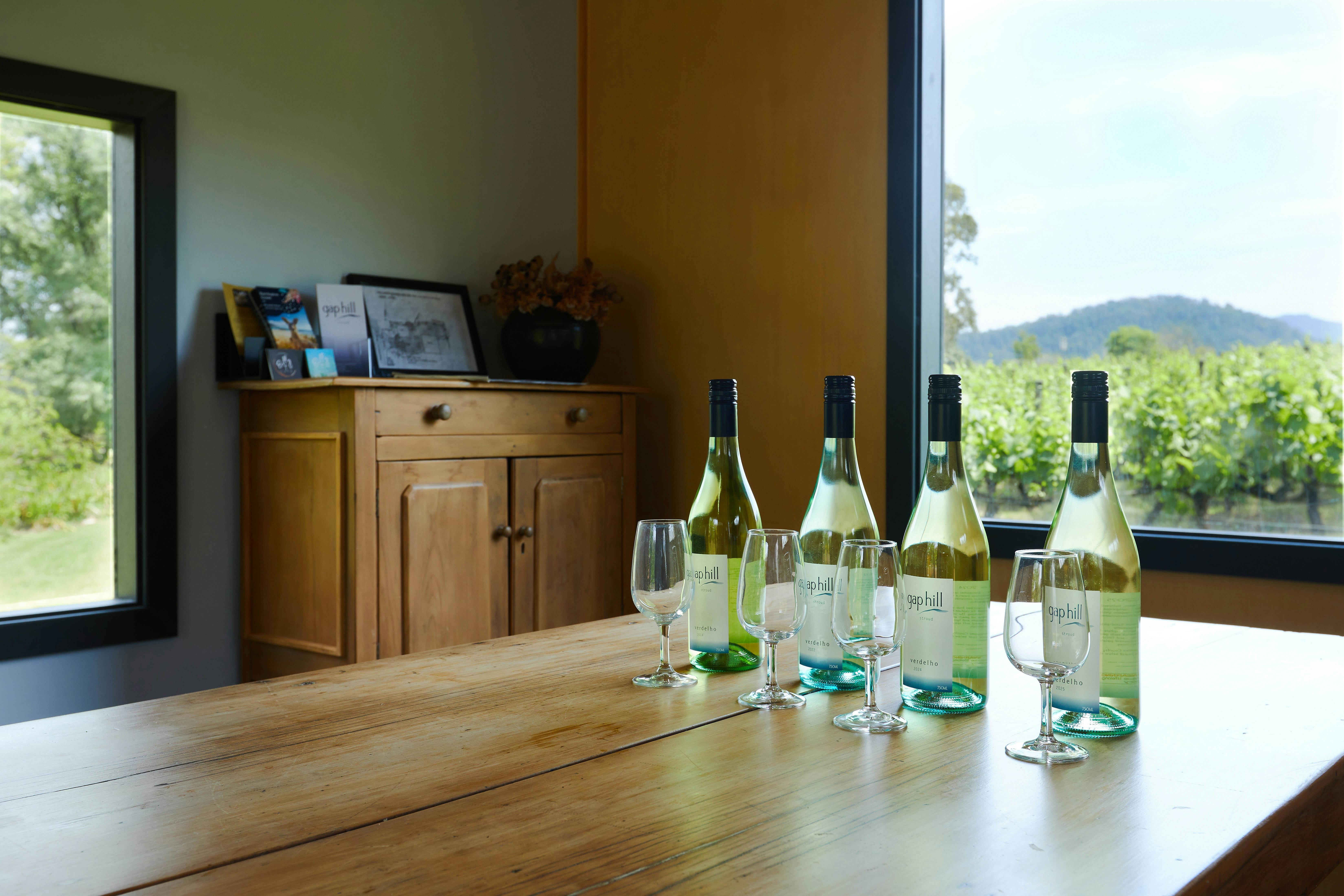 Inside the Cellar Door on the table are 4 bottles of estate grown, handpicked, Verdelho wine bottles