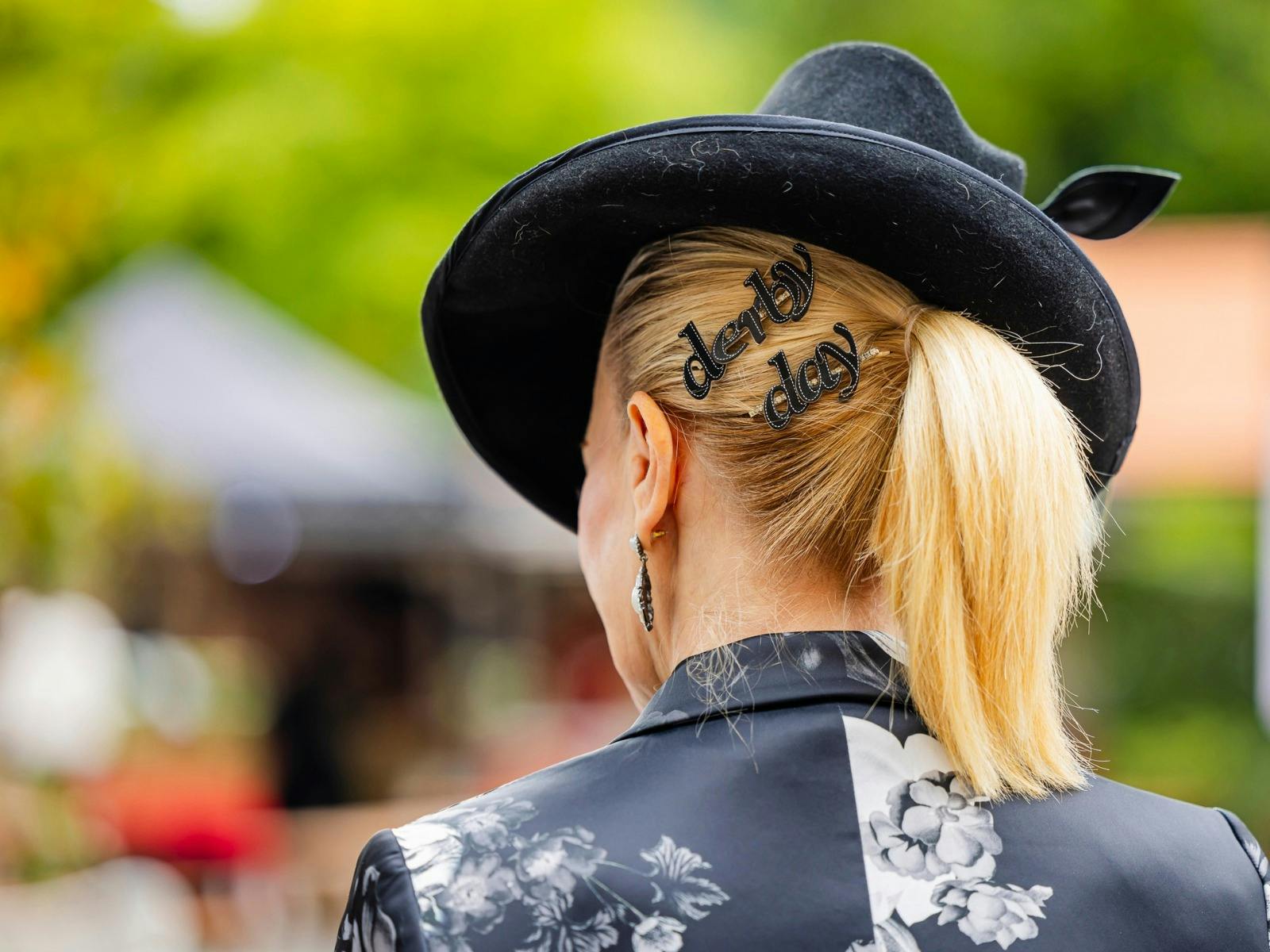 A lady at Derby Day in a fashionable hat.