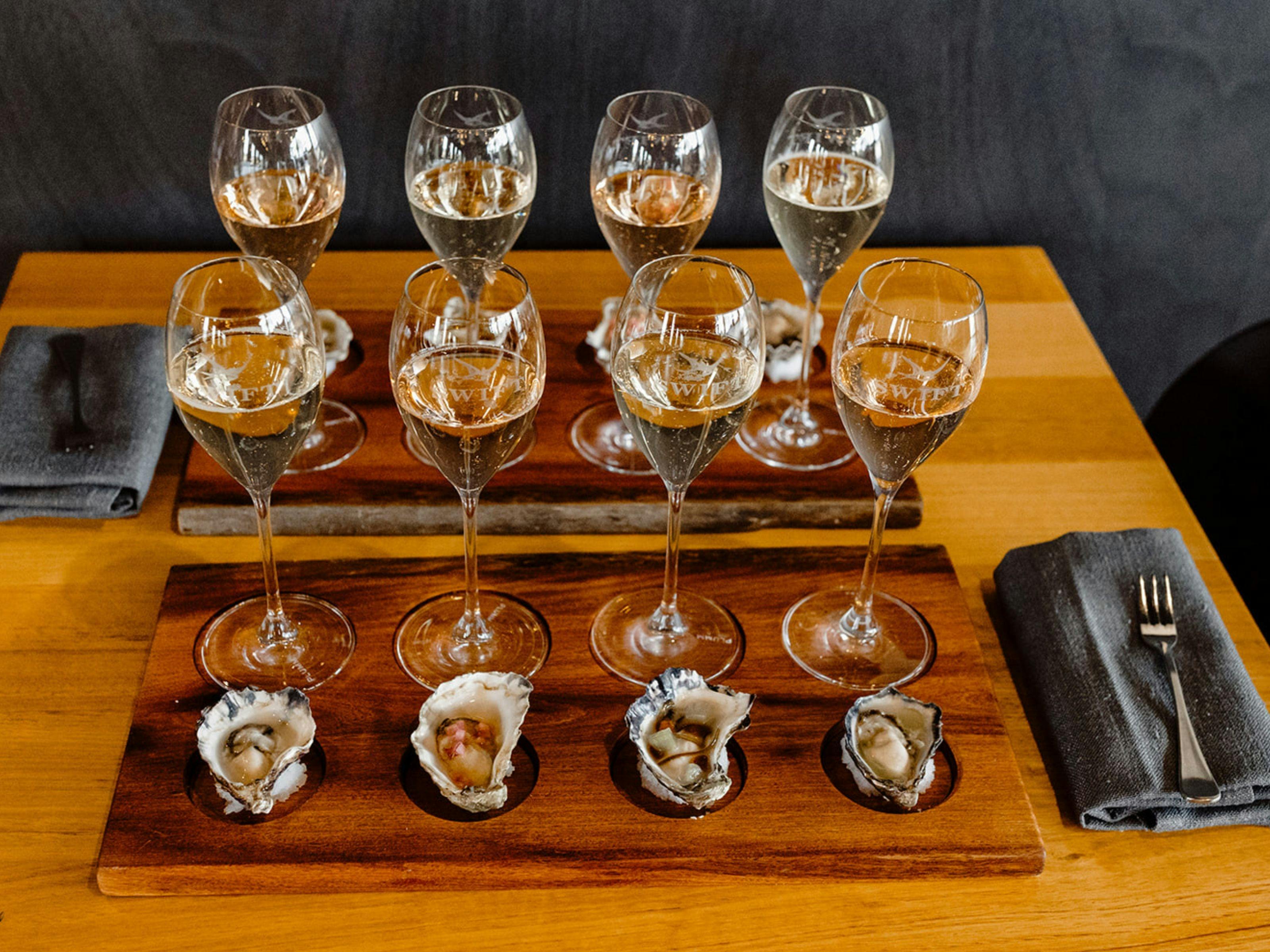 Set up showing the oyster and sparkling experience on hand crafted timber trays