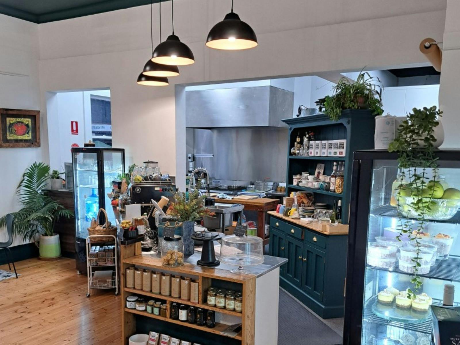 Front service counter at the store with things on display and items in the fridge