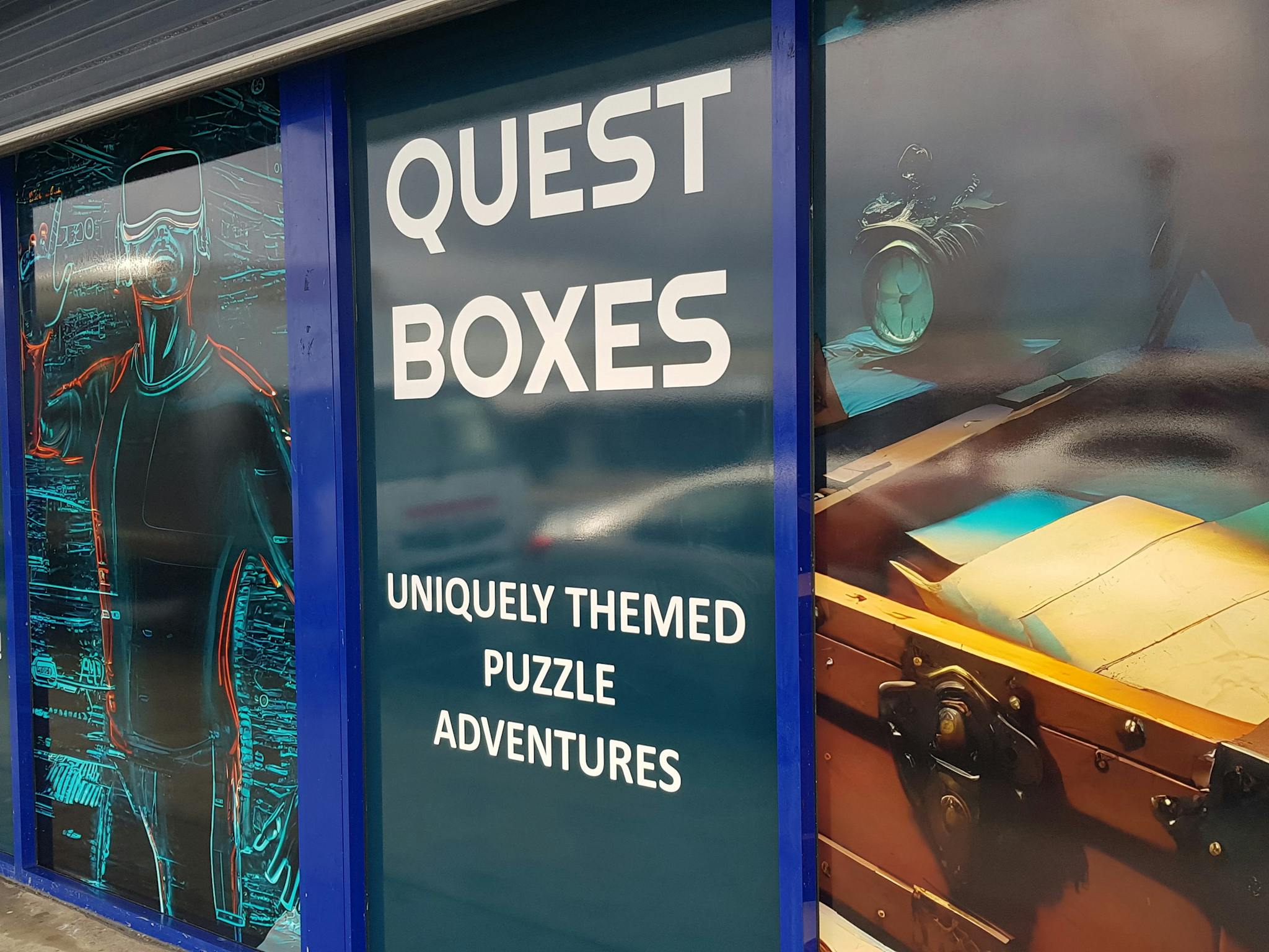 Single-level storefront with full-height signs showing virtual reality games and puzzle boxes.
