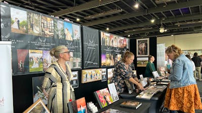 Attendee chatting with Exhibitor at Your Local Wedding Guide Expo.
