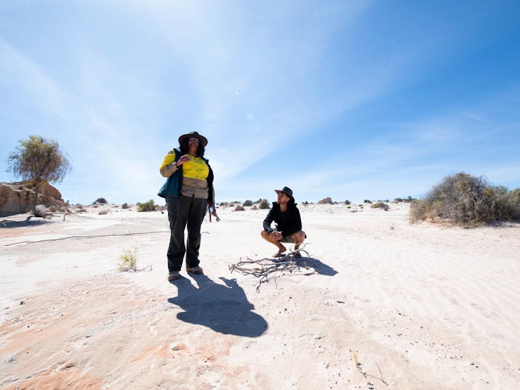 Man learning about the geology of the outback on a guided tour in Mungo National Park