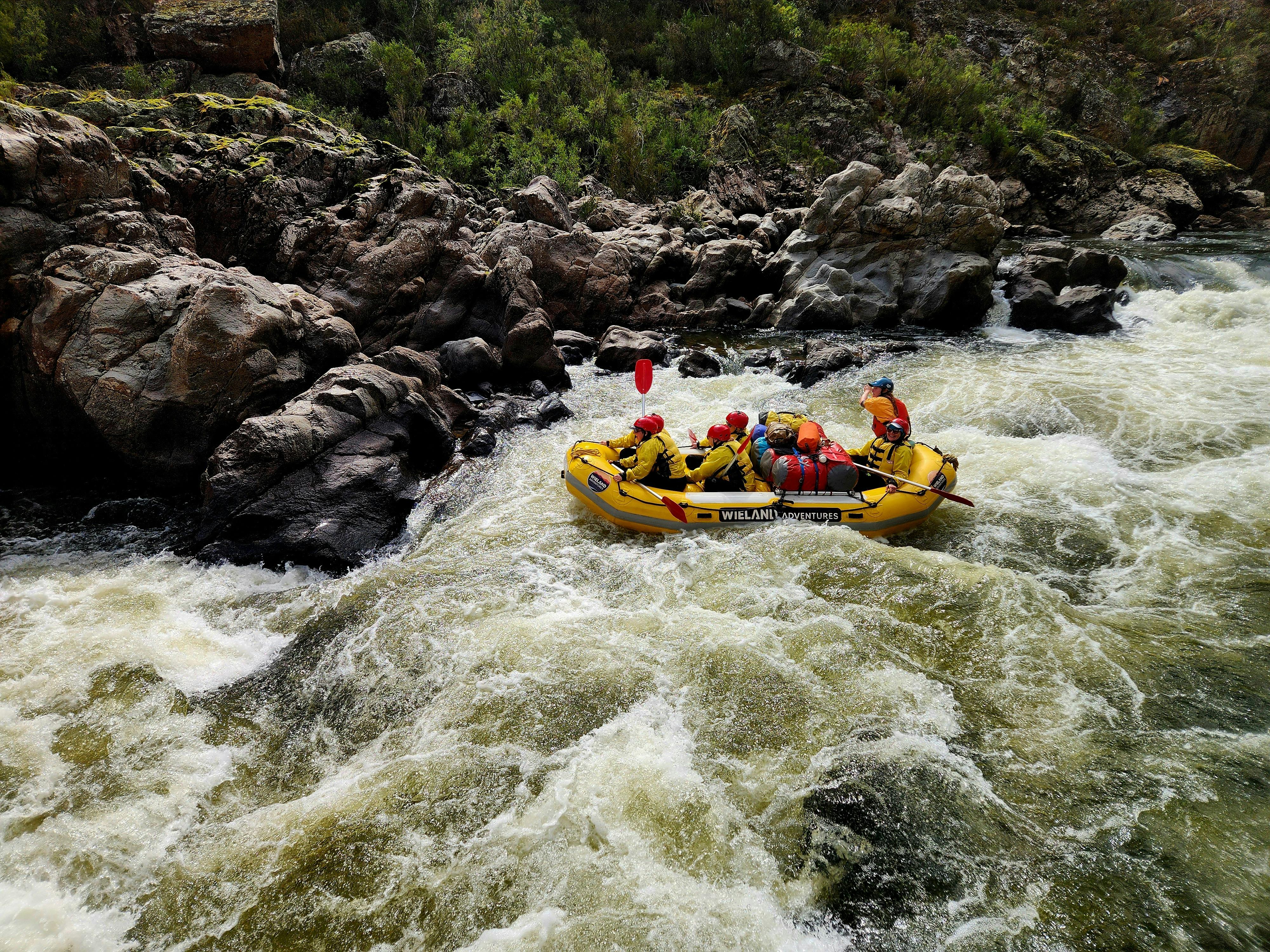 A yellow raft loaded with clients about to go over the main drop in 'George's Mistake II Rapid'.