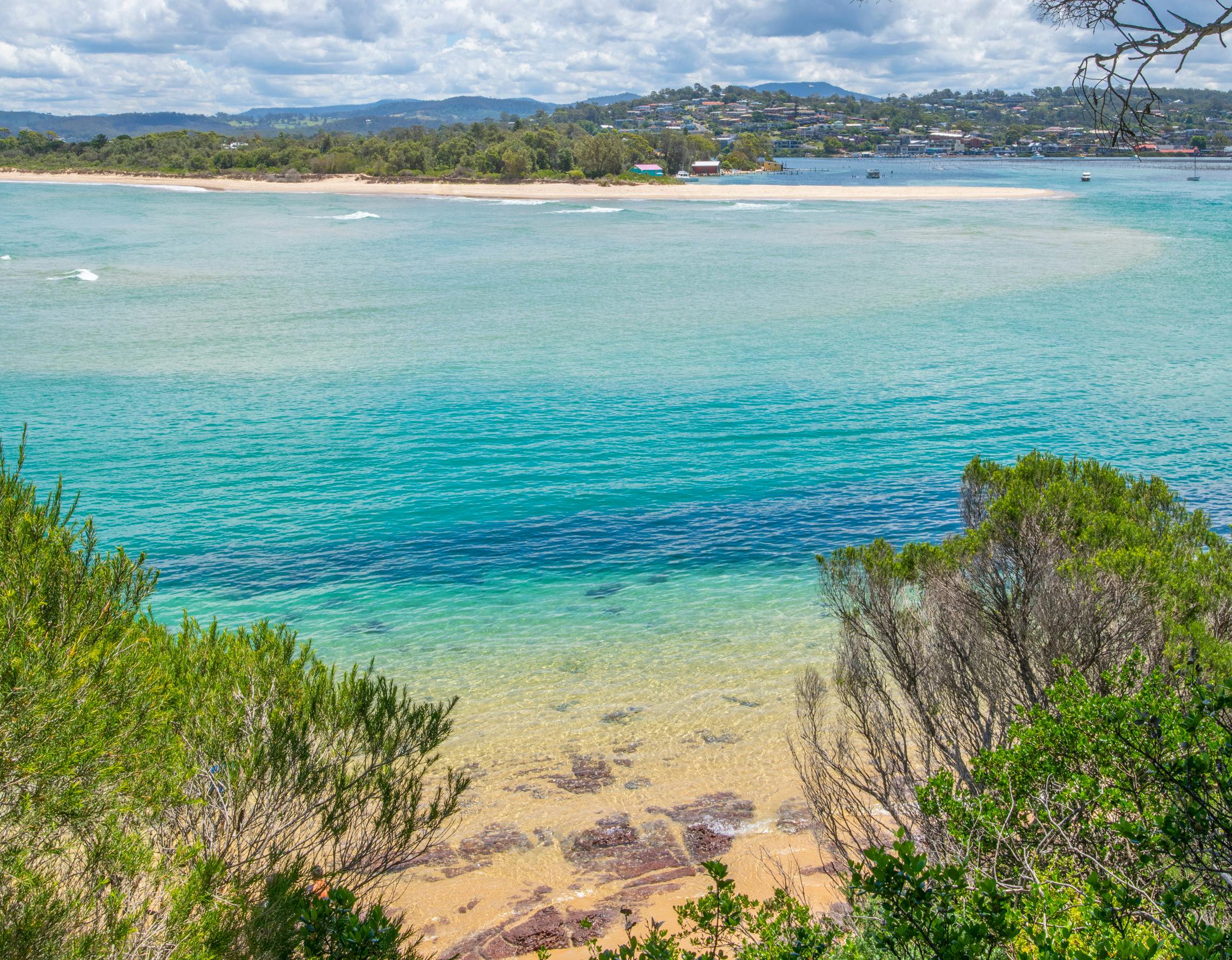 View over Merimbula Lake showing the beautiful aqua colours of the lake and ocean.