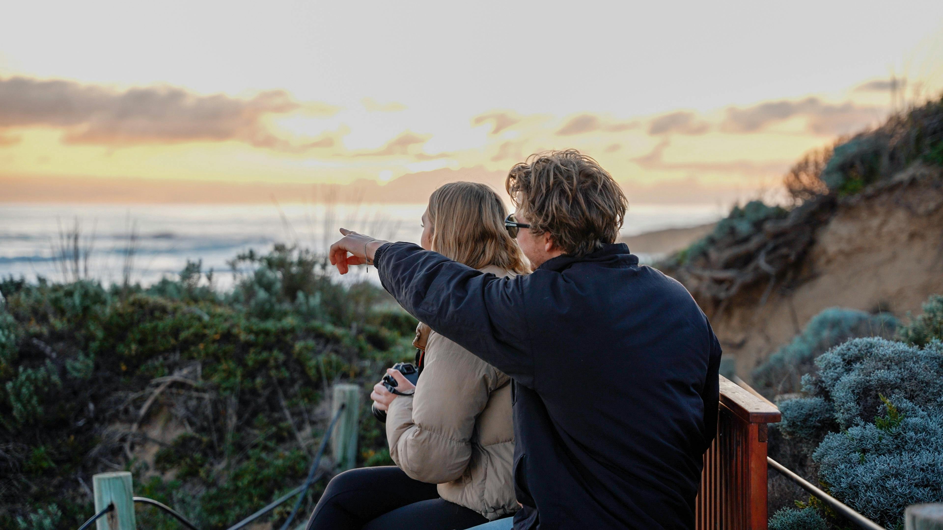 Couple enjoying the sights while on tour. Seated having a glass of wine.