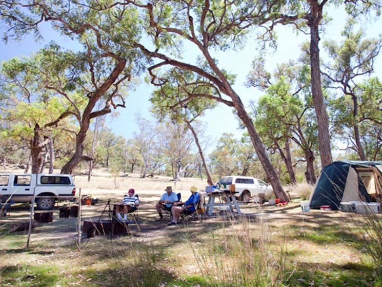 A group of people sitting beside their tent and car at Big River campground, Goulburn River National