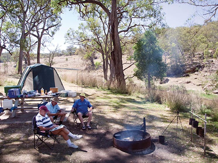 A group of campers around a fire ring at Big River campground in Goulburn National Park. Photo: Nick