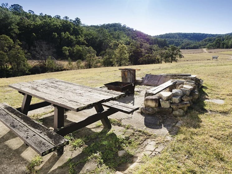 Fire pit and picnic table outside Big Yango House, Yengo National Park. Photo: Simone Cottrell/OEH