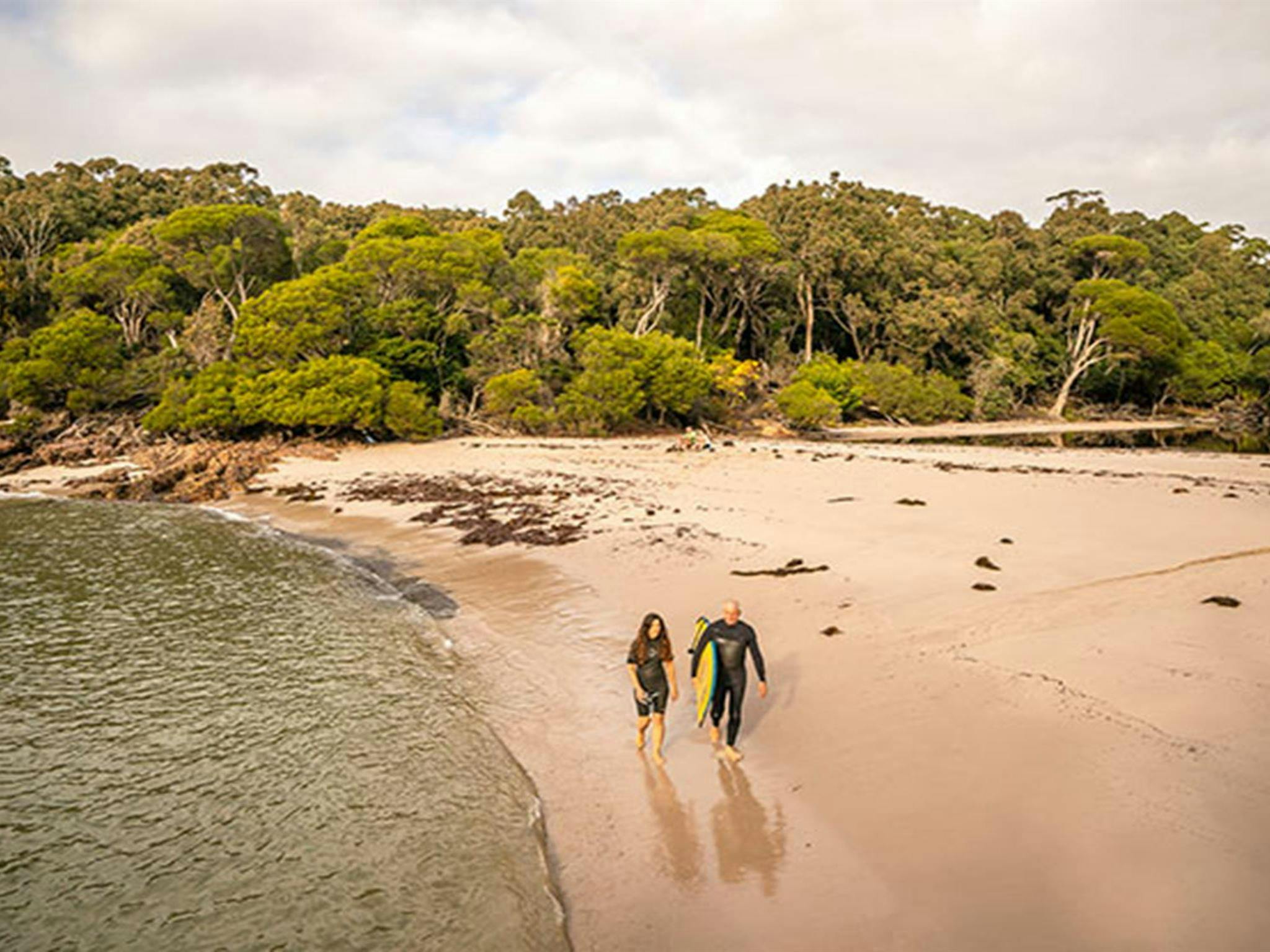 People walking along the sand at Bittangabee Bay. Photo: John Spencer/OEH