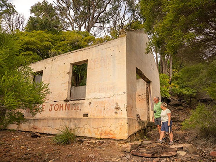 A couple inspecting the historic ruins at Bittangabee Bay. Photo: John Spencer/OEH