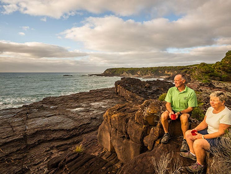 People relaxing on ocean cliffs at Bittangabee campground, Beowa National Park. Photo: John