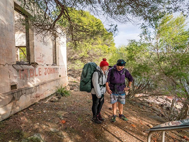 Bushwalkers at ruins near Bittangabee campground in Beowa National Park. Photo: John Spencer/OEH
