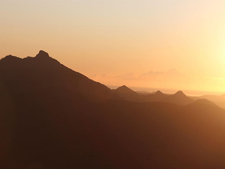 Silhouette of Wollumbin - Mount Warning as the sun rises over the Tweed Valley, seen from Blackbutt