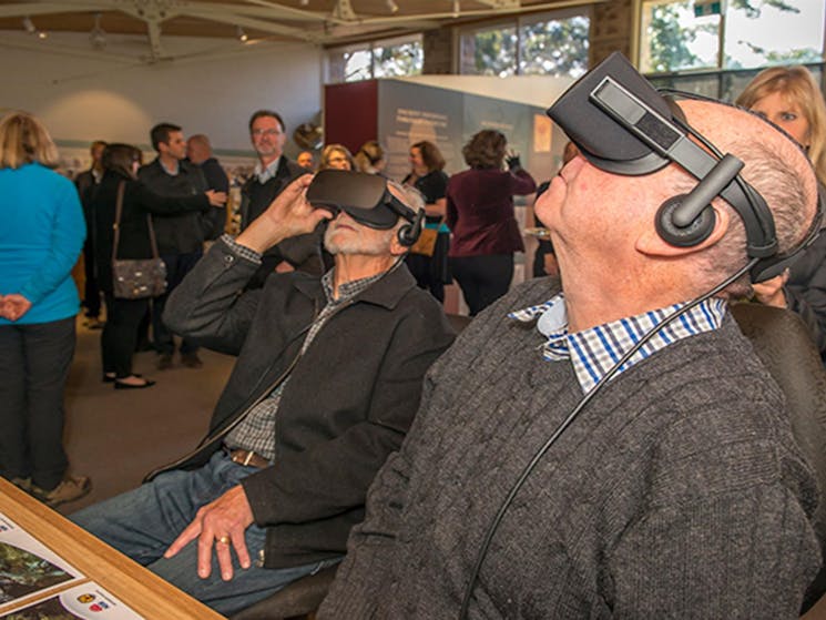 Visitors use goggles and headphones for a virtual reality experience, at Blue Mountains Heritage