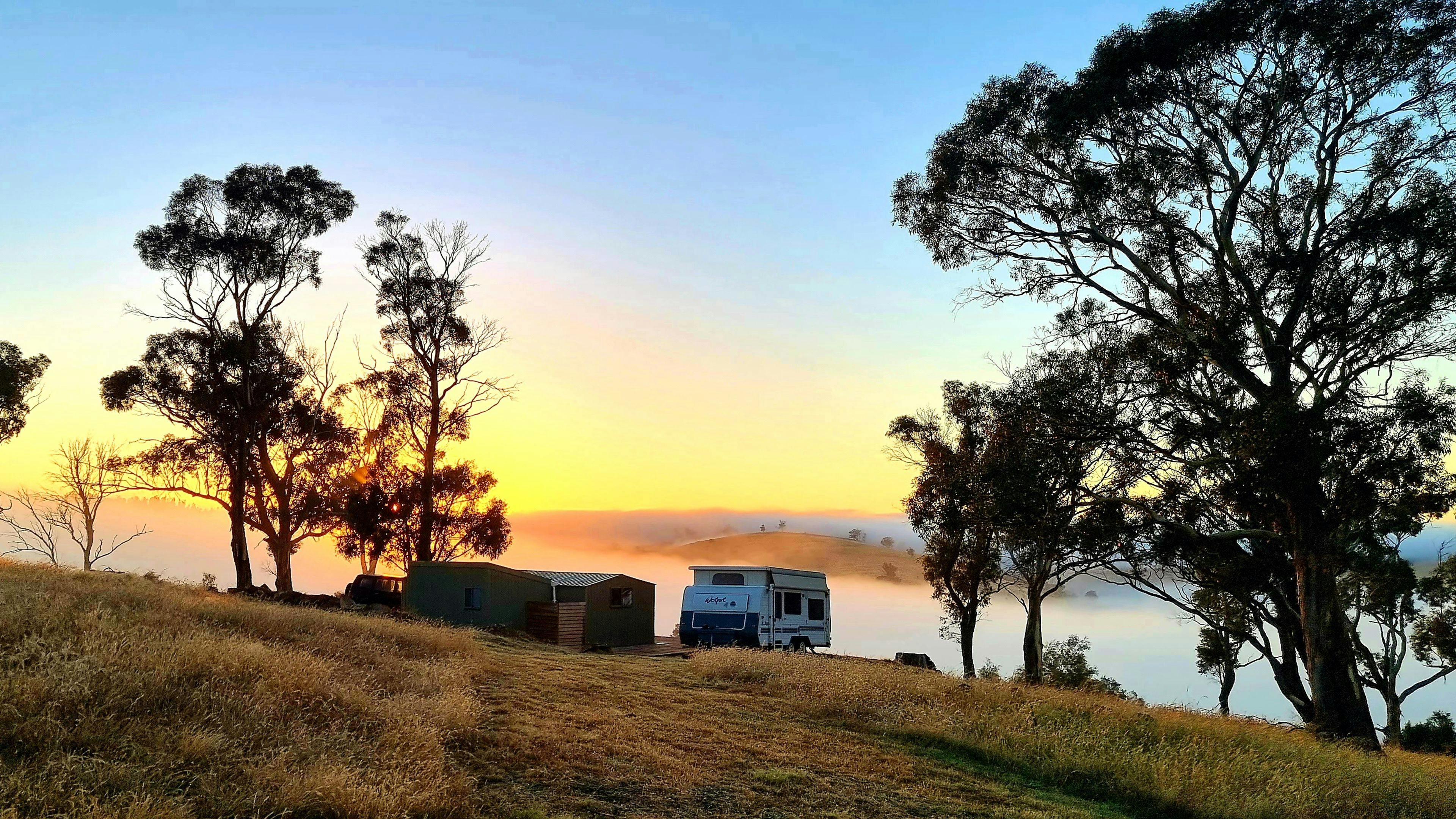 Cabin and van at sunrise