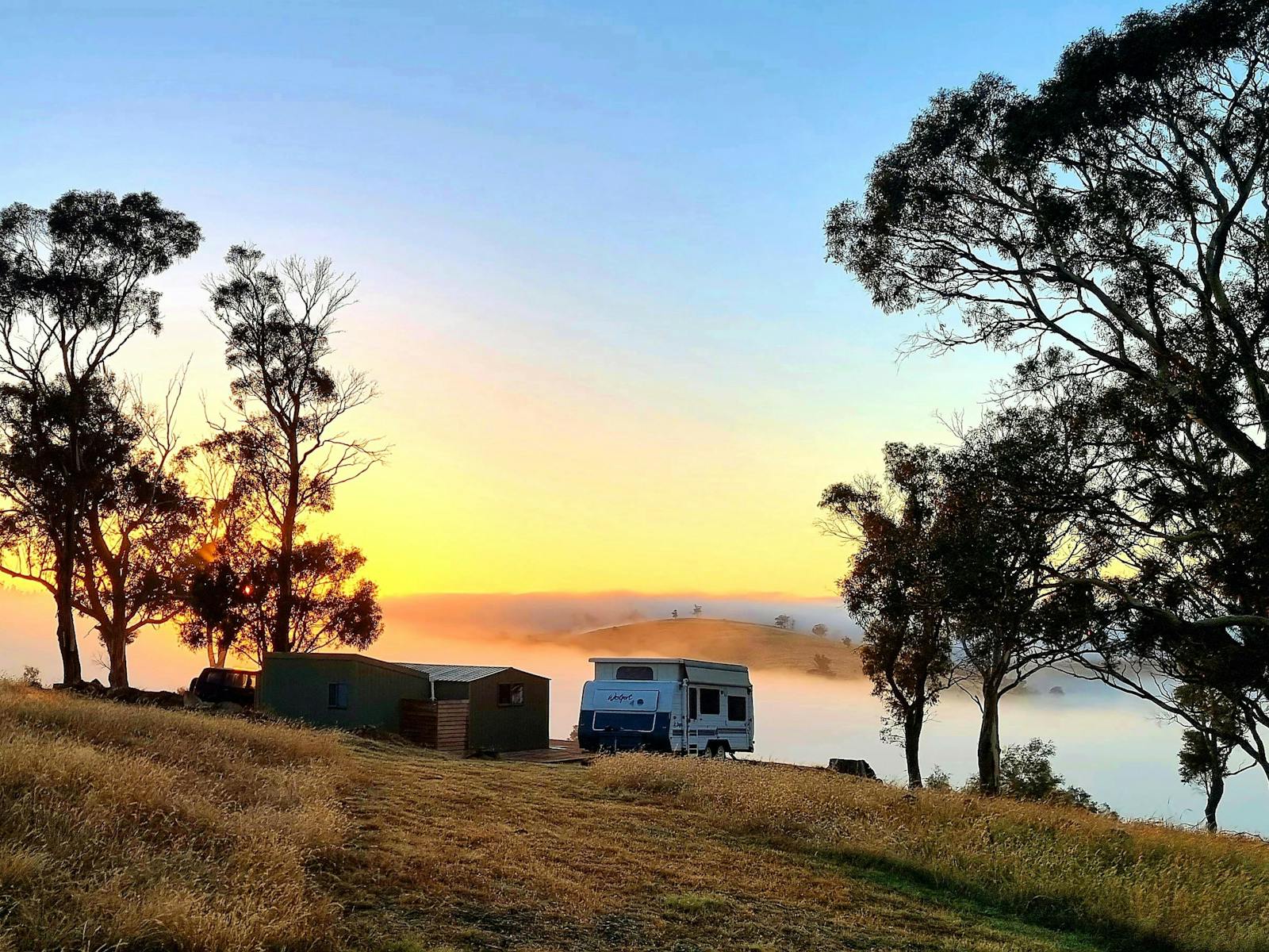 Cabin and van at sunrise