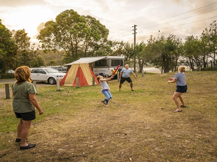 Visitors enjoying a casual game of cricket outside their campervan at Bonnie Vale. Photo: John