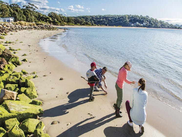A family takes a walk along the beach next to Bonnie Vale picnic area in Royal National Park. Photo: