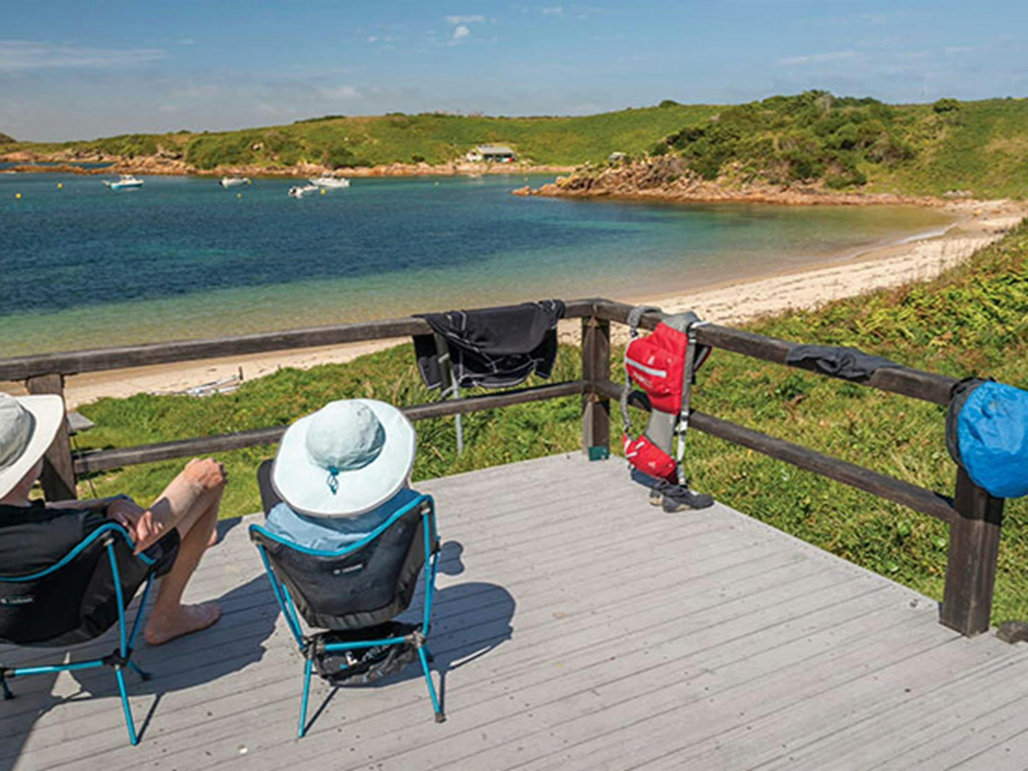 2 people enjoying the view on the camping platform at Broughton Island campground, Myall Lakes