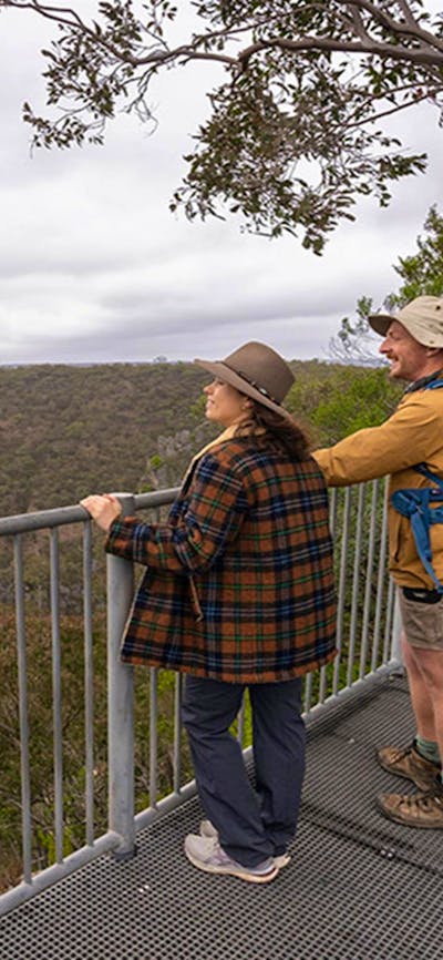 Visitors admiring the view from Adams lookout in Bungonia National Park. Photo: John Spencer/DCCEEW