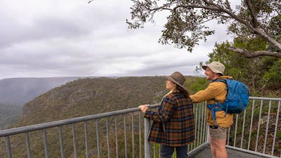Visitors admiring the view from Adams lookout in Bungonia National Park. Photo: John Spencer/DCCEEW
