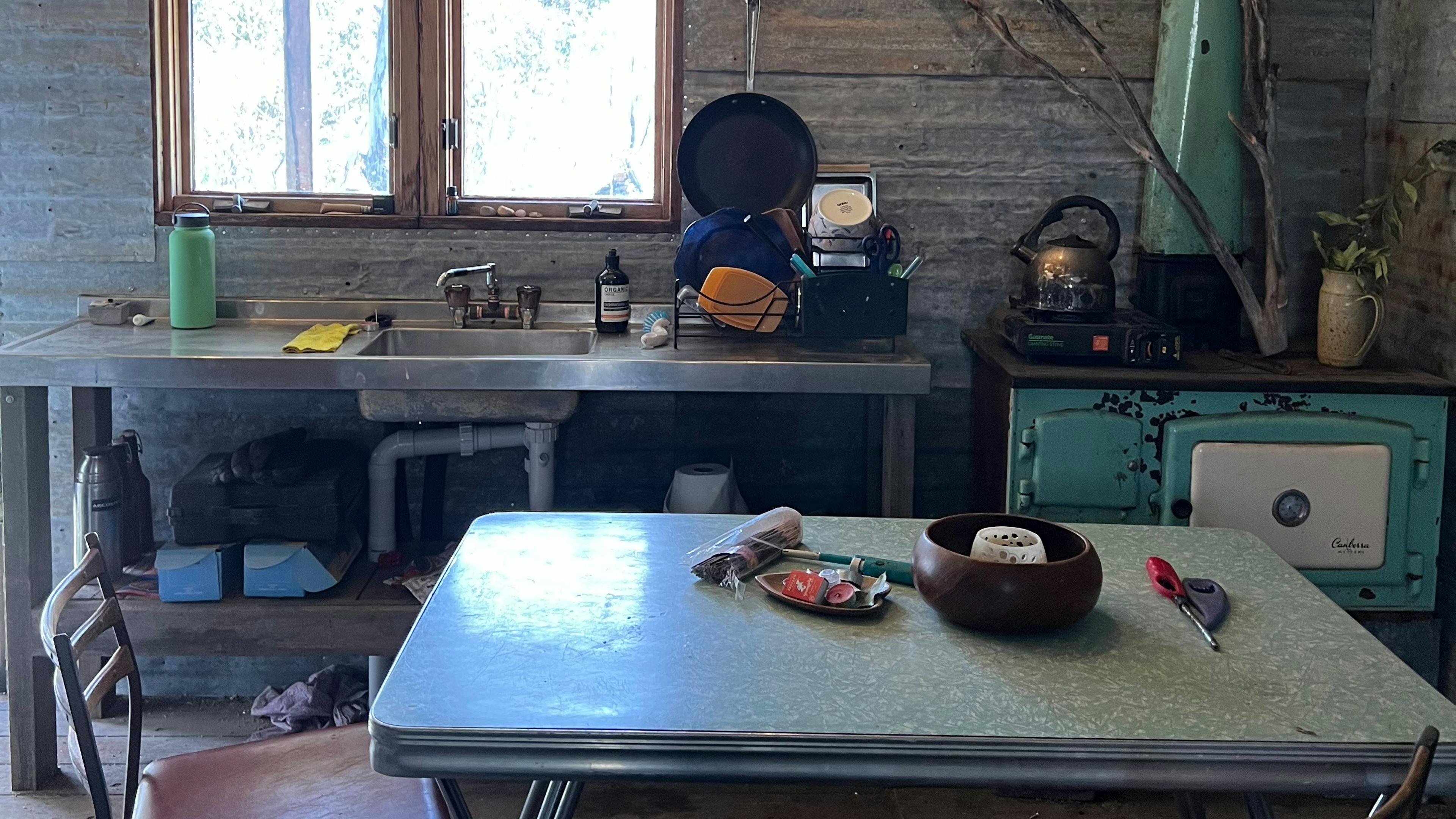 Kitchen has sink with gas hot water and wood burning stove. There is also a butane gas cooker available. 