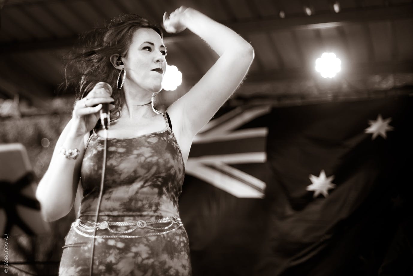 Female vocalist with Australian flag in background