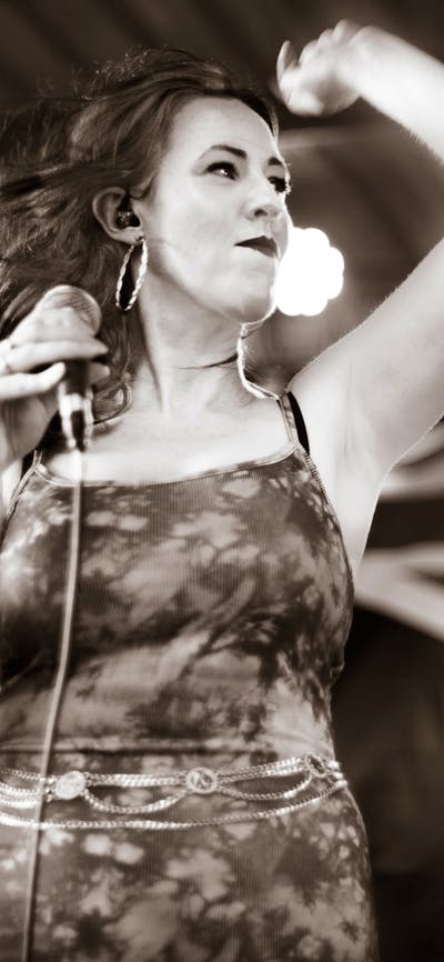 Female vocalist with Australian flag in background