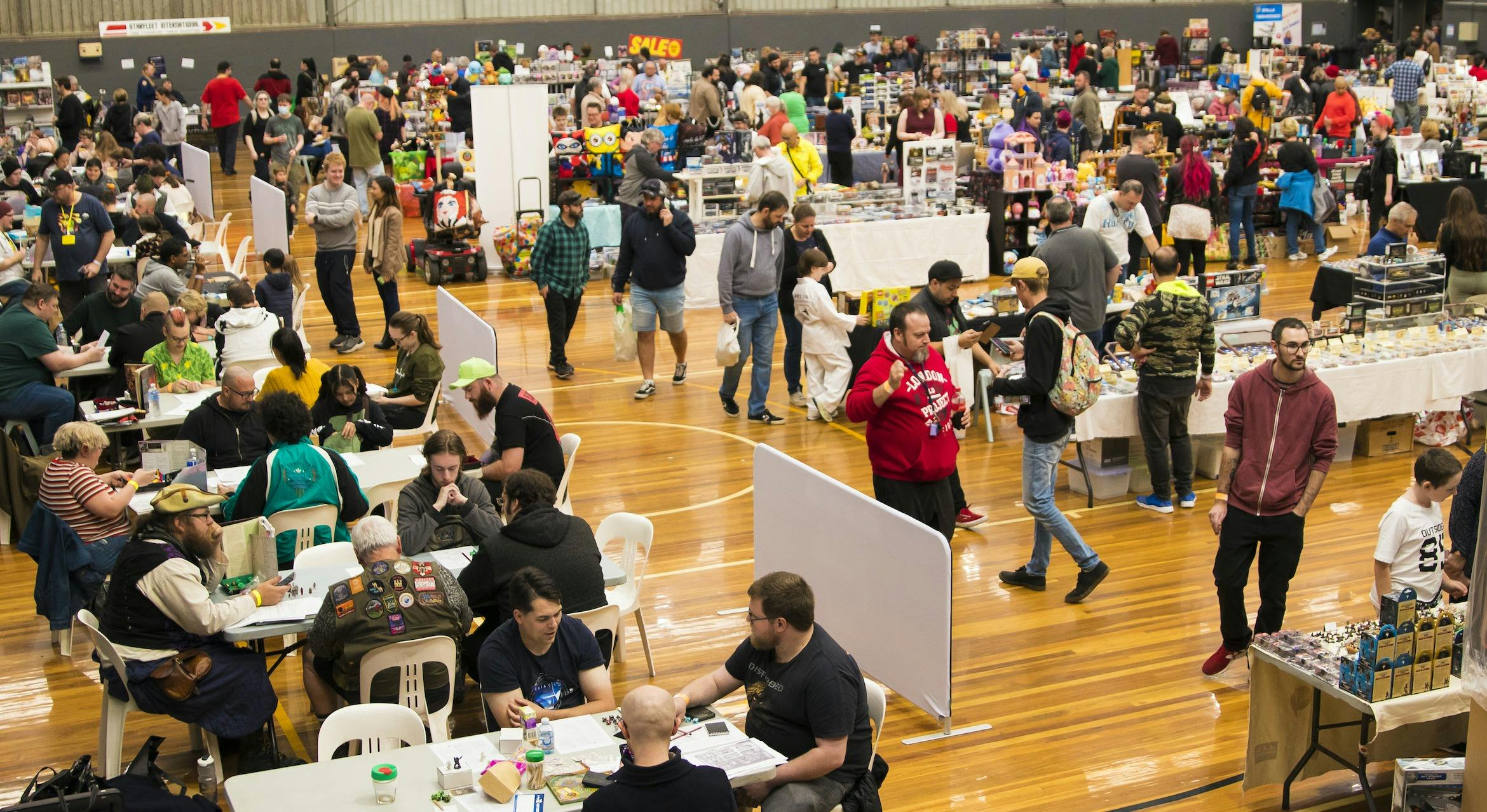 High angle shot of Dungeons and Dragons tables panning out to trading tables