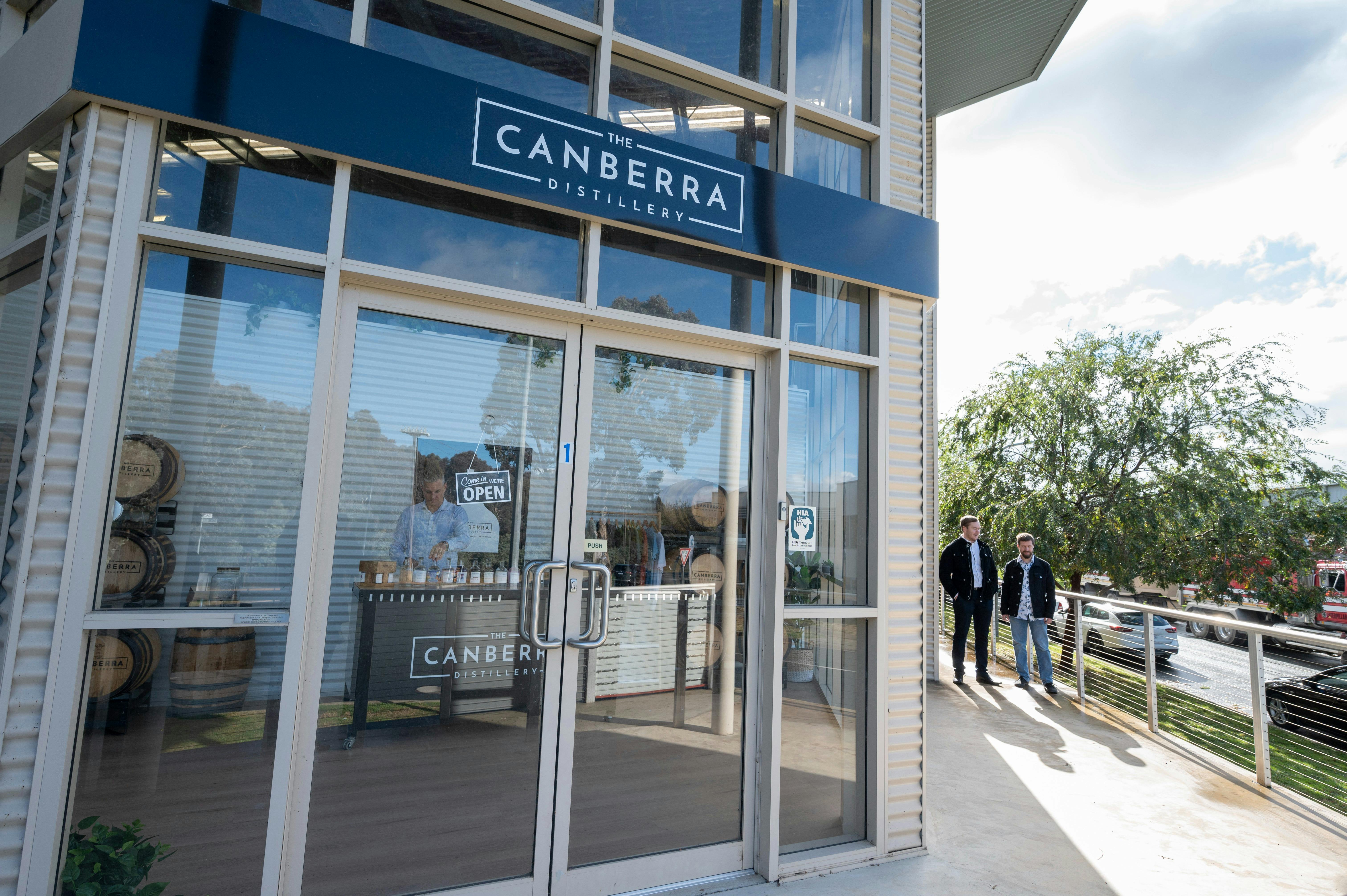 The Canberra Distillery shopfront with two men approaching