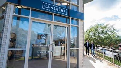 The Canberra Distillery shopfront with two men approaching