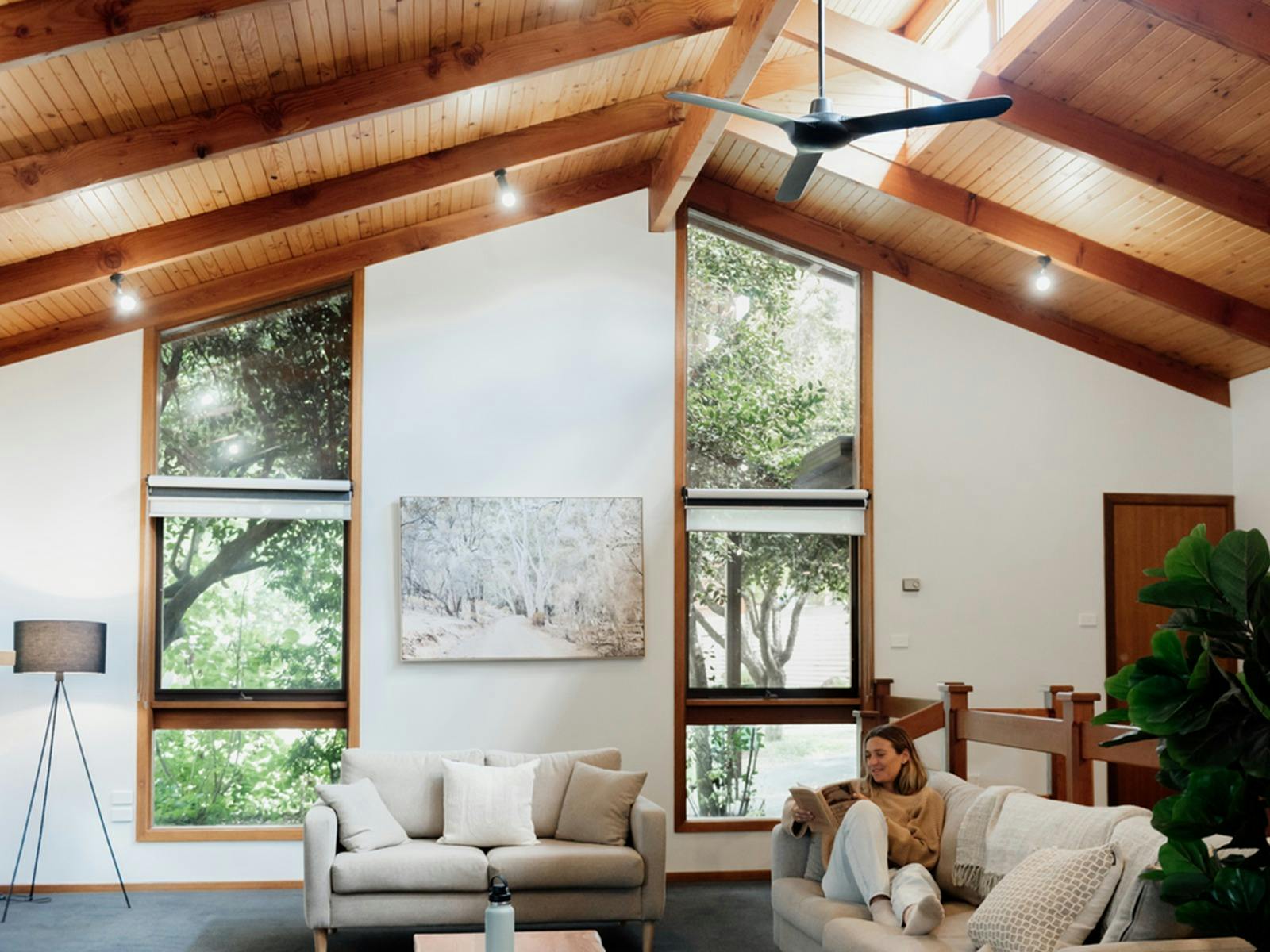 A woman sits comfortably in a living room
