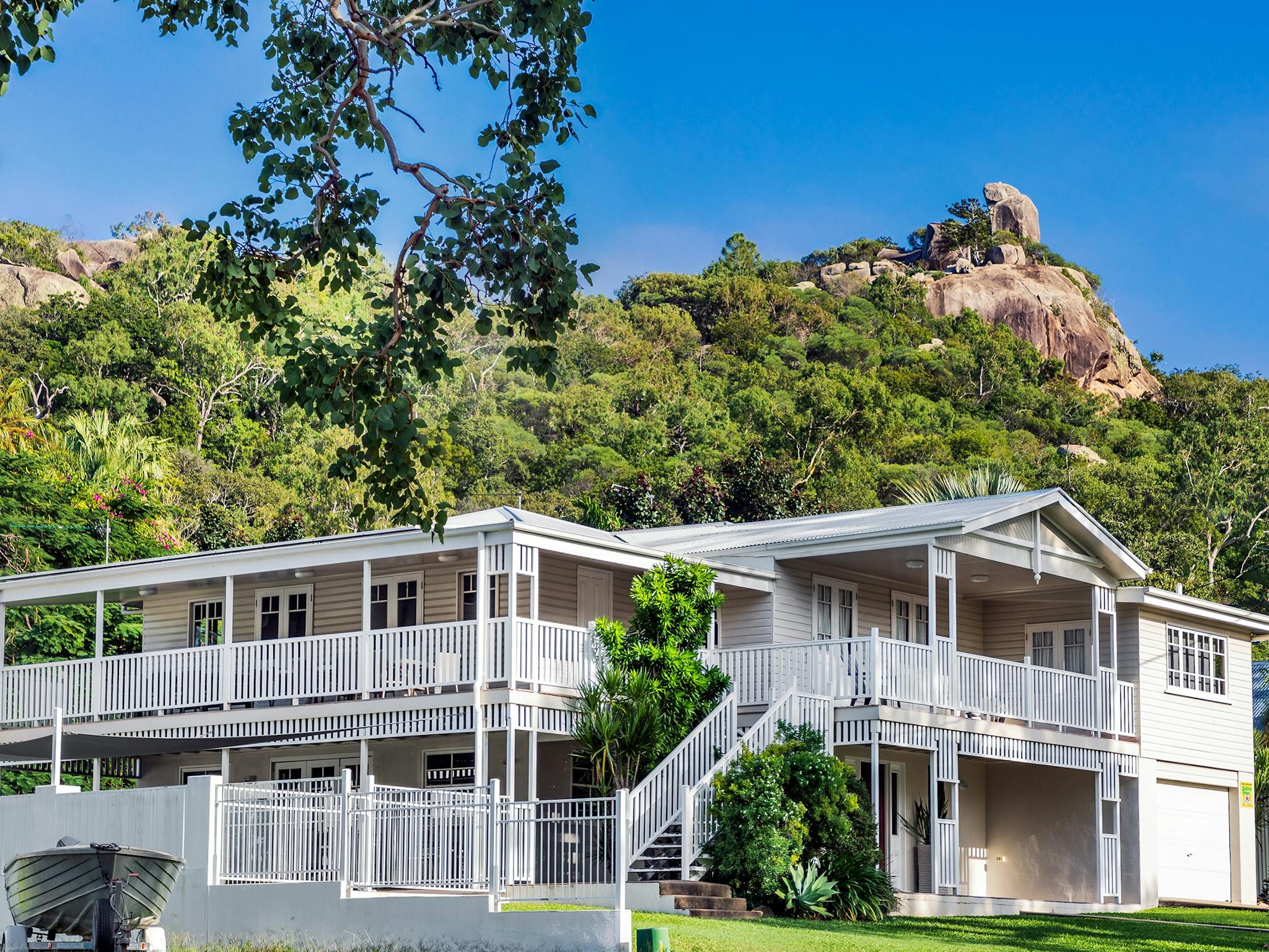 Beautiful white Queenslander style house at Picnic Bay on Magnetic Island, with scenic rocks. Beautiful white Queenslander style house at Picnic Bay on Magnetic Island, with scenic rocks.