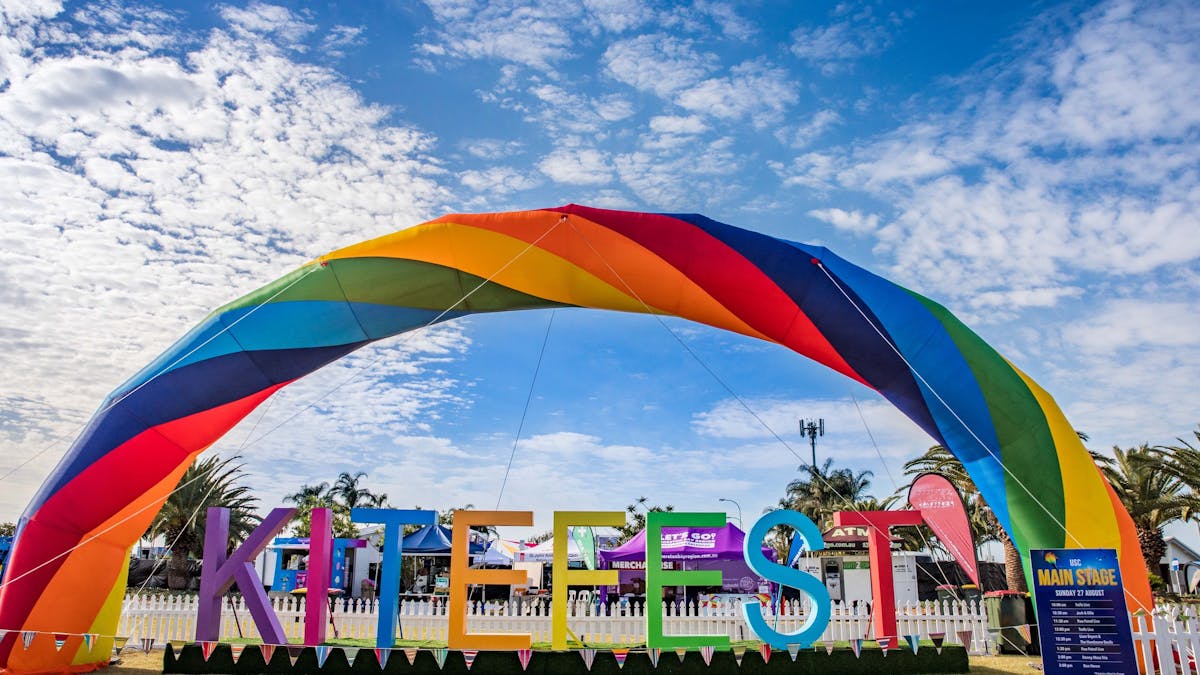Rainbow coloured large KiteFest sign