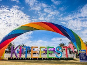 Rainbow coloured large KiteFest sign