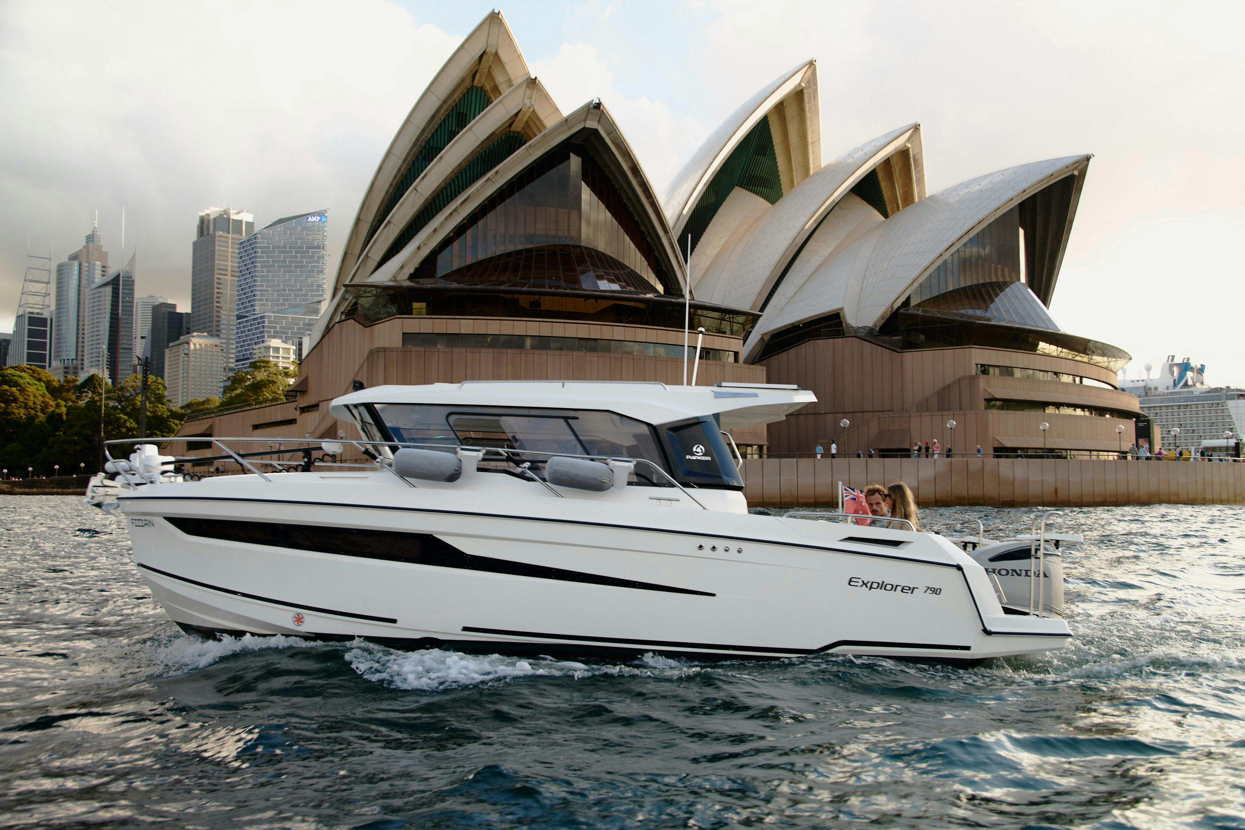 MV Explorer luxury cruise boat on Sydney Harbour with Harbour Bridge in the background.